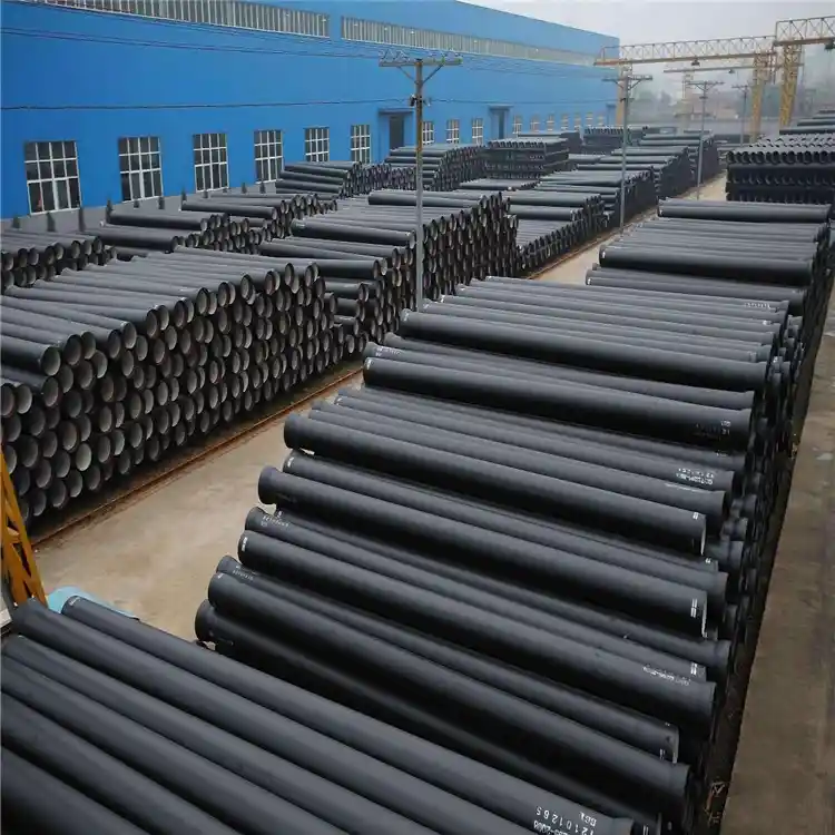 Large industrial stockyard of black coated ISO 2531 ductile iron pipes for water projects
